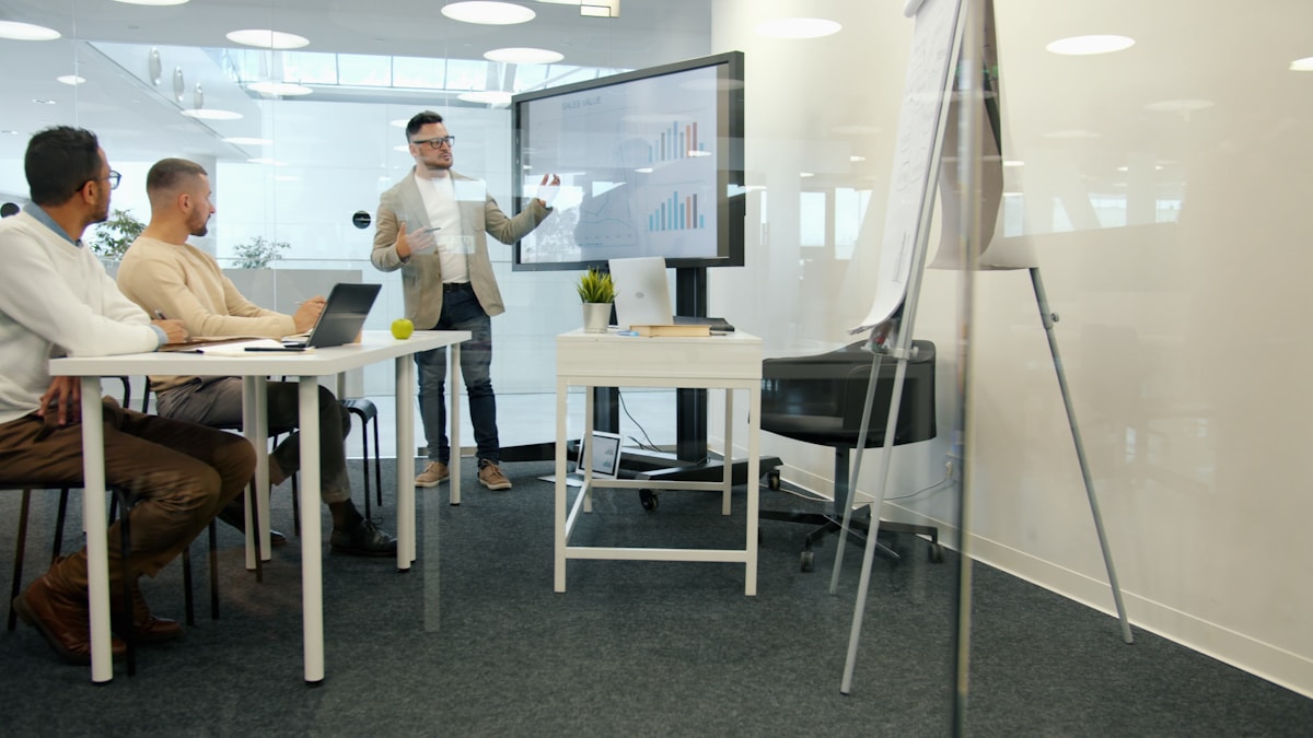 Business professional presenting sales results to team in a corporate boardroom