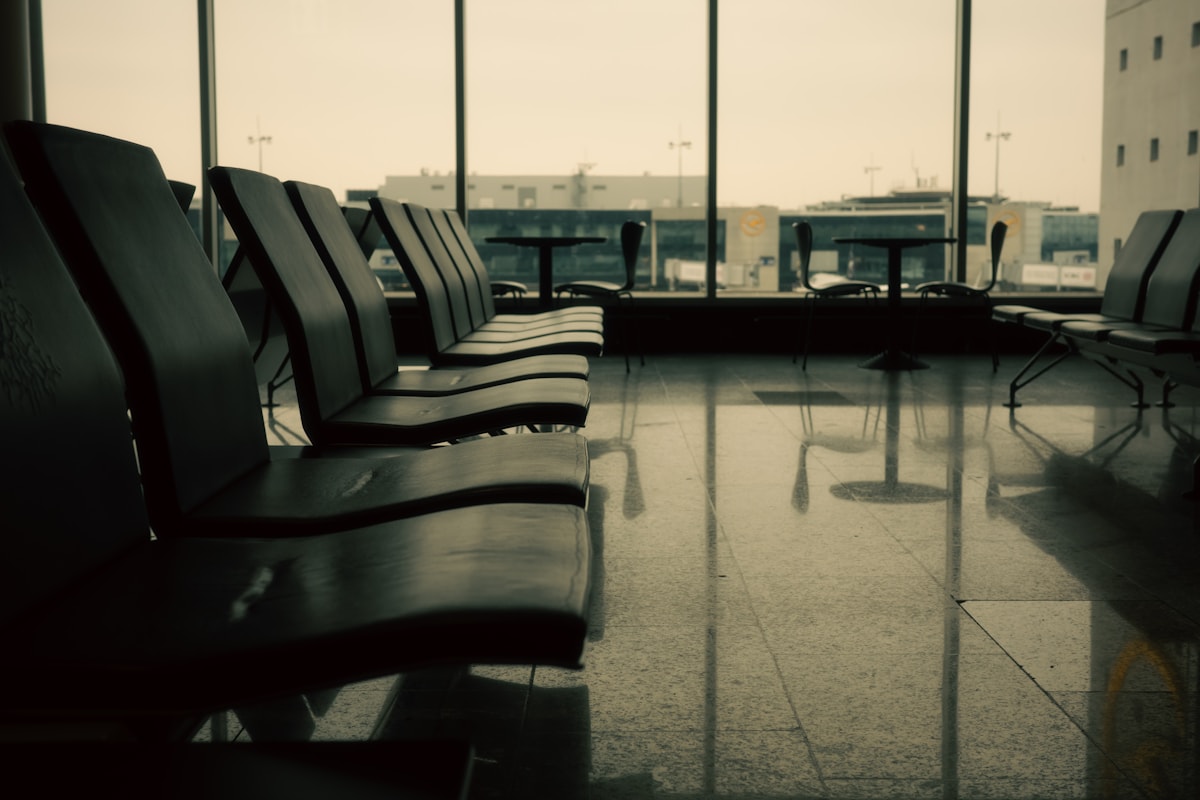 Empty airport waiting area with rows of modern seating at a departure gate
